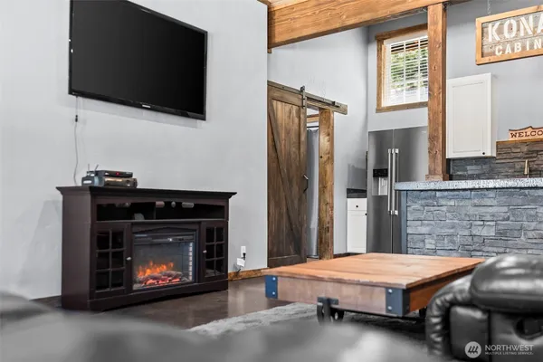 a living room with furniture a flat screen tv and a fireplace