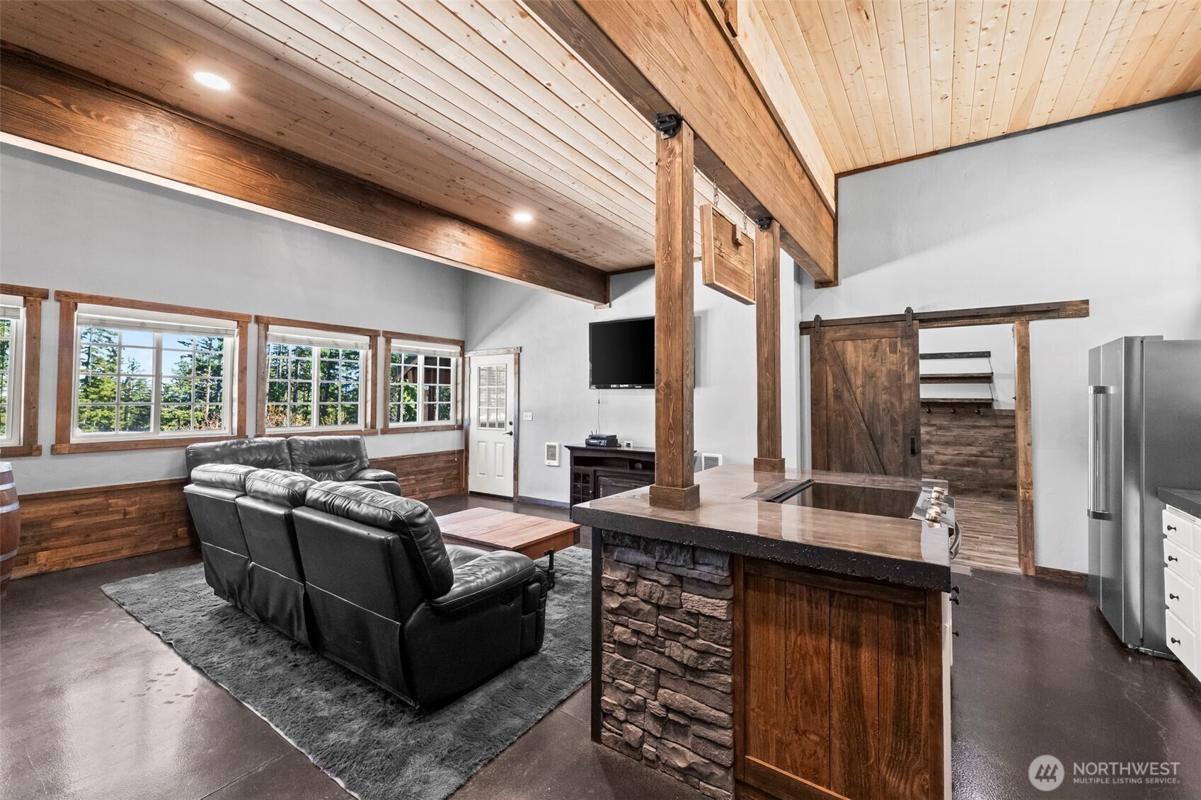 130 Horse Heaven Road Cle Elum, WA 98922 - Photo 19 of 34 a living room with couches a flat screen tv and kitchen view