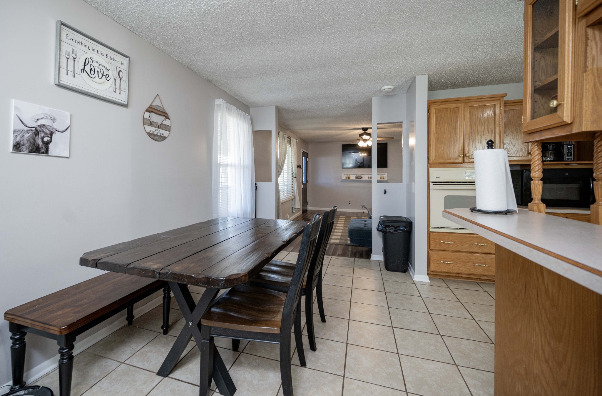 6620 Amanda Way Murfreesboro, TN 37129 - Photo 7 of 23 a kitchen with stainless steel appliances kitchen island granite countertop a dining table chairs and a refrigerator