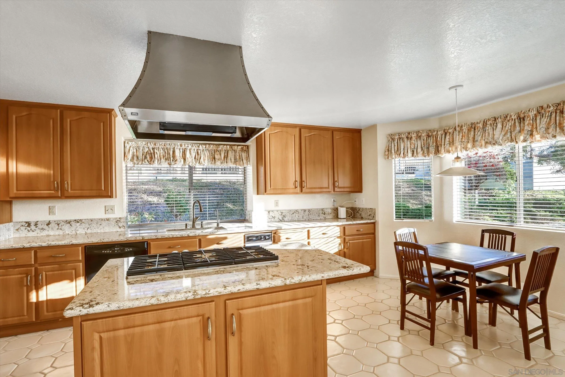 1840 Cabernet Drive Chula Vista, CA 91913 - Photo 15 of 66 a kitchen with a stove a sink a counter top space and dining table