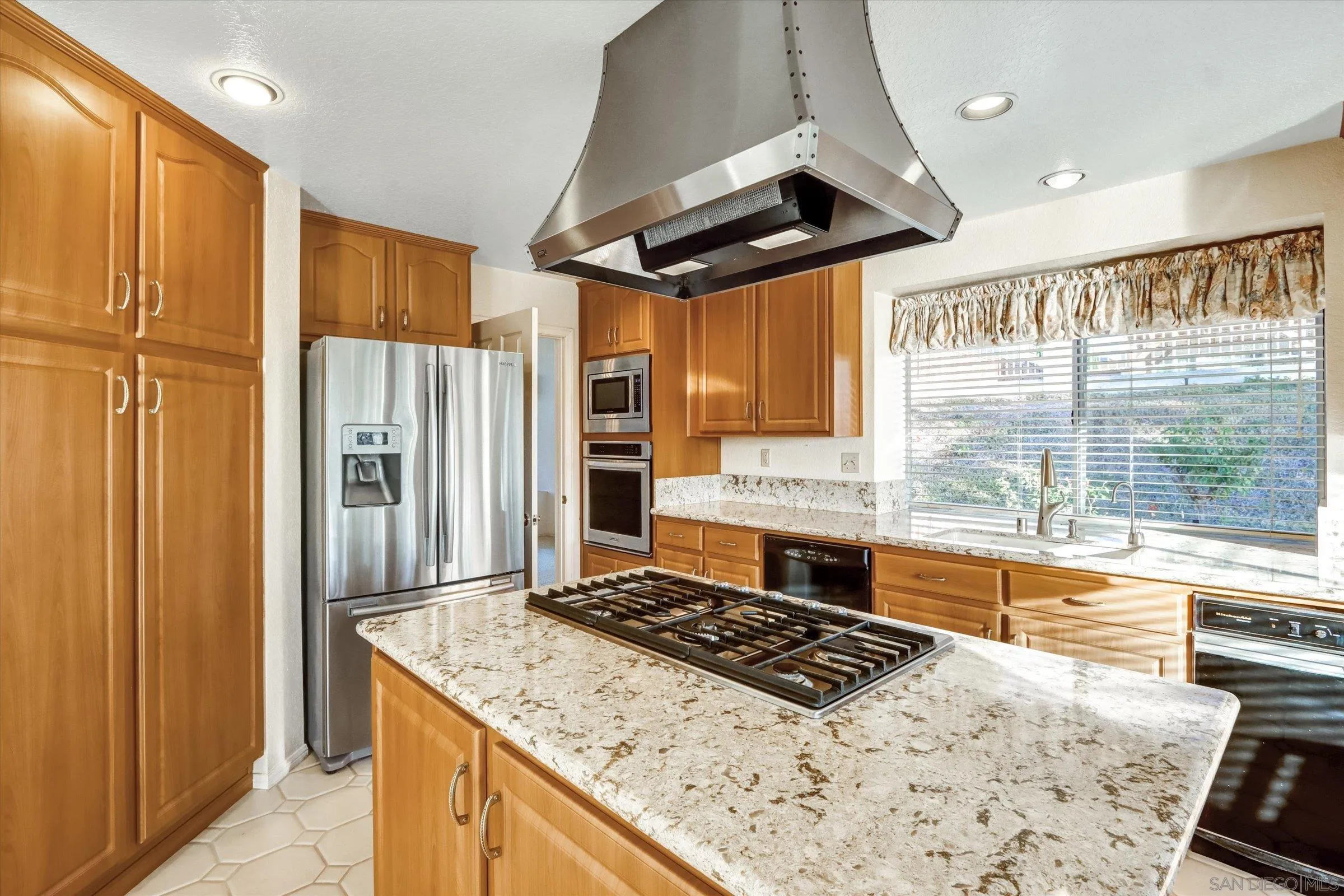 1840 Cabernet Drive Chula Vista, CA 91913 - Photo 16 of 66 a kitchen with stainless steel appliances granite countertop a stove a refrigerator and a refrigerator