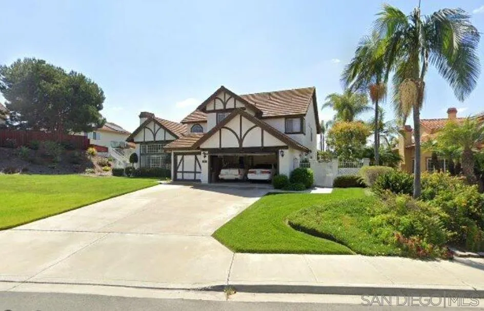 1840 Cabernet Drive Chula Vista, CA 91913 - Photo 2 of 66 a front view of a house with a garden and trees