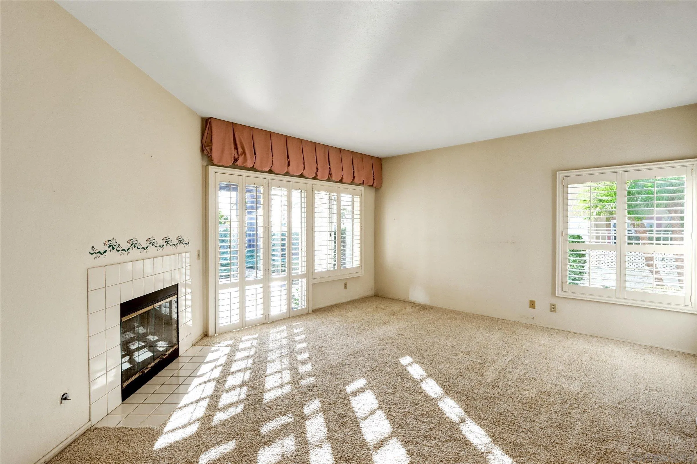 1840 Cabernet Drive Chula Vista, CA 91913 - Photo 22 of 66 a view of an empty room with a fireplace and a window