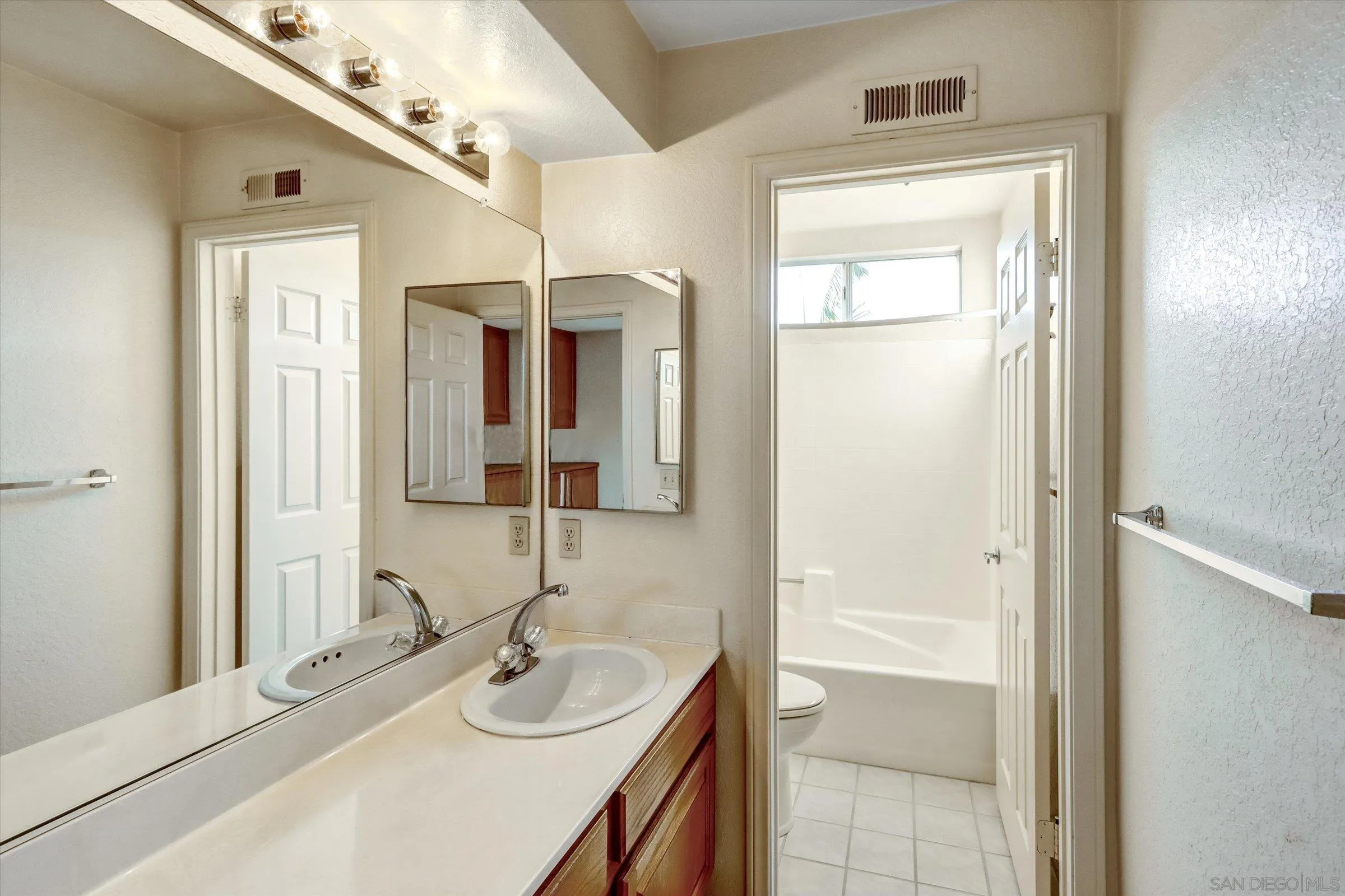 1840 Cabernet Drive Chula Vista, CA 91913 - Photo 36 of 66 a bathroom with a sink a vanity and a mirror