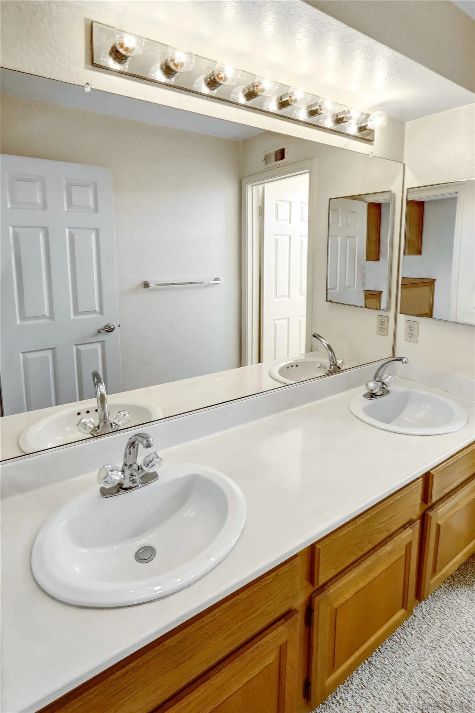 1840 Cabernet Drive Chula Vista, CA 91913 - Photo 37 of 66 a bathroom with a sink and a mirror