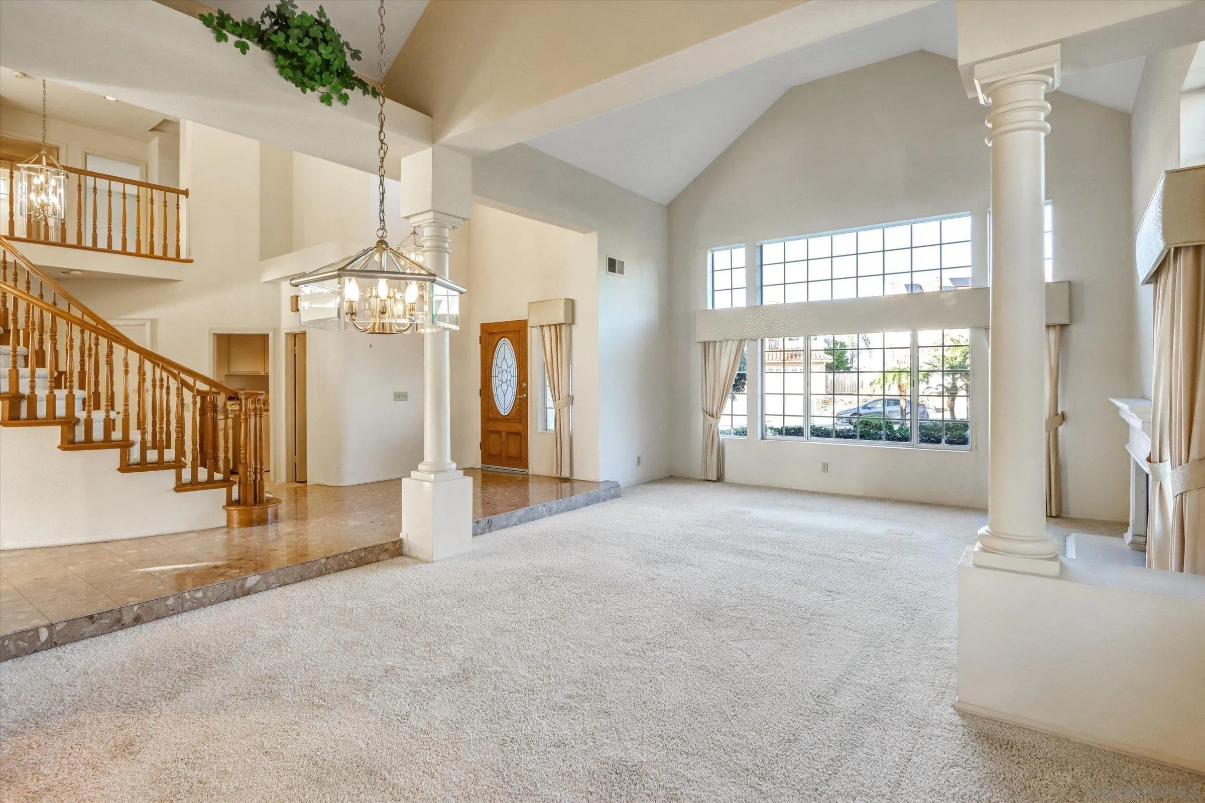 1840 Cabernet Drive Chula Vista, CA 91913 - Photo 10 of 66 a view of a livingroom with a chandelier curtains and large windows