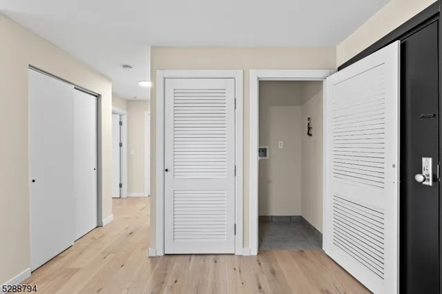 a view of a hallway with wooden floor