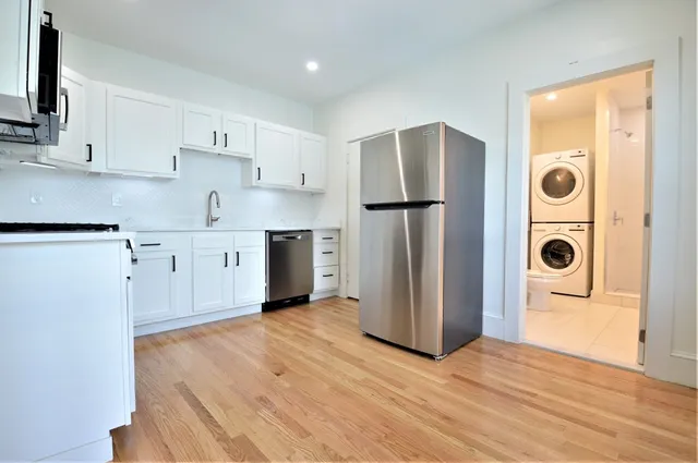 a kitchen with stainless steel appliances a refrigerator and a stove top oven