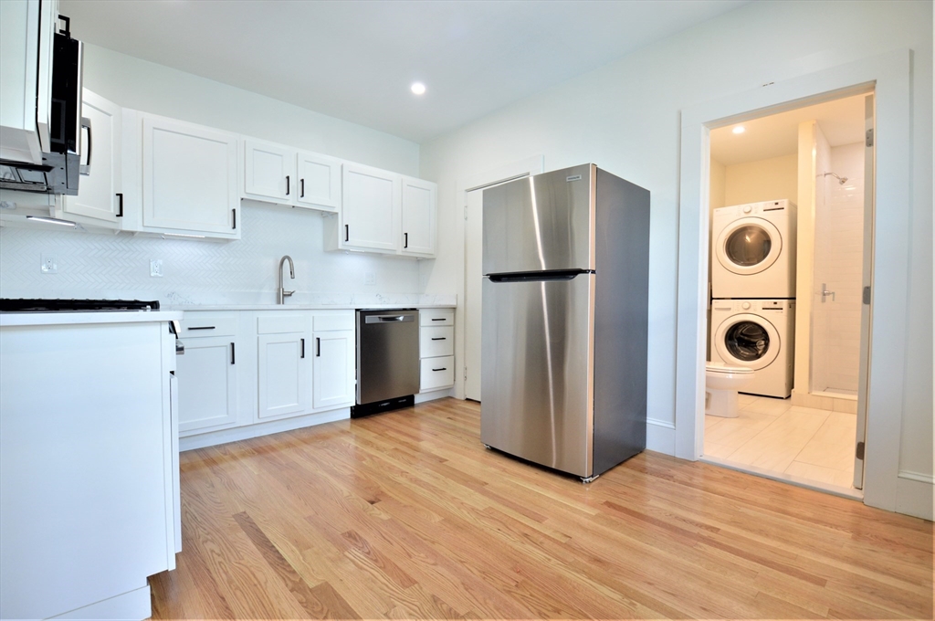 a kitchen with stainless steel appliances a refrigerator and a stove top oven