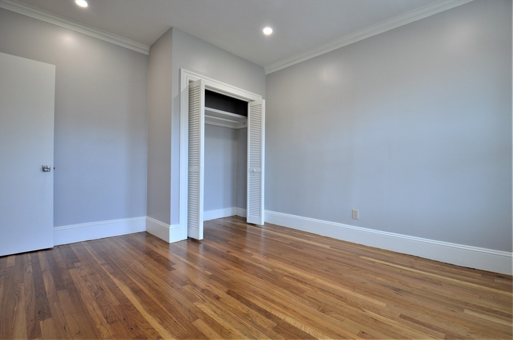 27 Ransom Road, Unit 2 Boston, MA 02135 - Photo 12 of 29 a view of an empty room with wooden floor