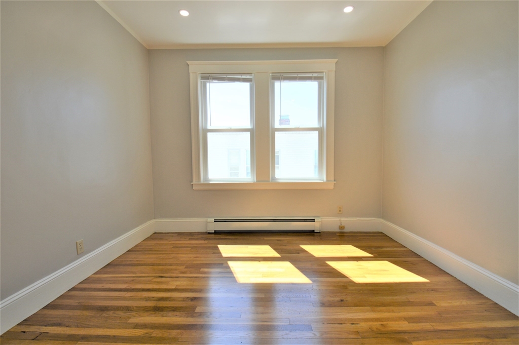 27 Ransom Road, Unit 2 Boston, MA 02135 - Photo 16 of 29 a view of a room with wooden floor and a window
