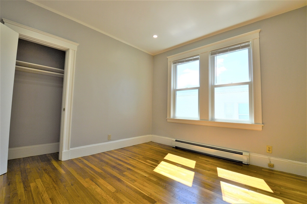 27 Ransom Road, Unit 2 Boston, MA 02135 - Photo 17 of 29 a view of a room with wooden floor and cabinet