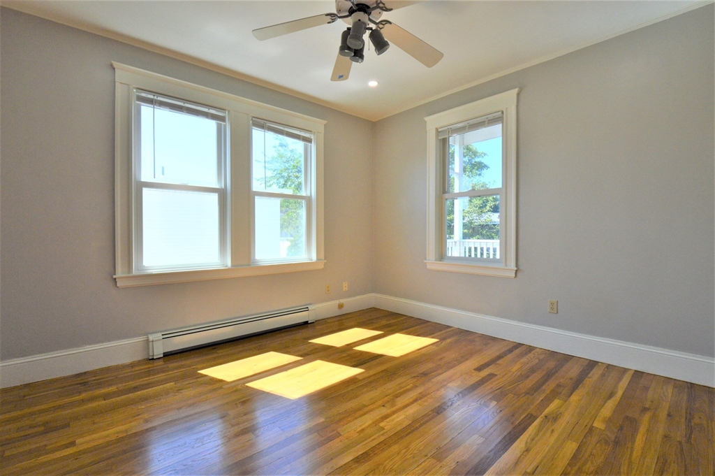 27 Ransom Road, Unit 2 Boston, MA 02135 - Photo 19 of 29 a view of empty room with wooden floor and fan