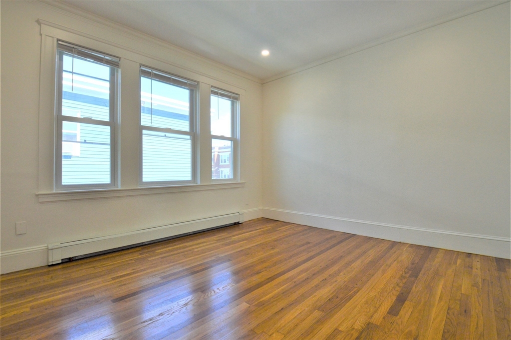 27 Ransom Road, Unit 2 Boston, MA 02135 - Photo 24 of 29 an empty room with wooden floor and windows