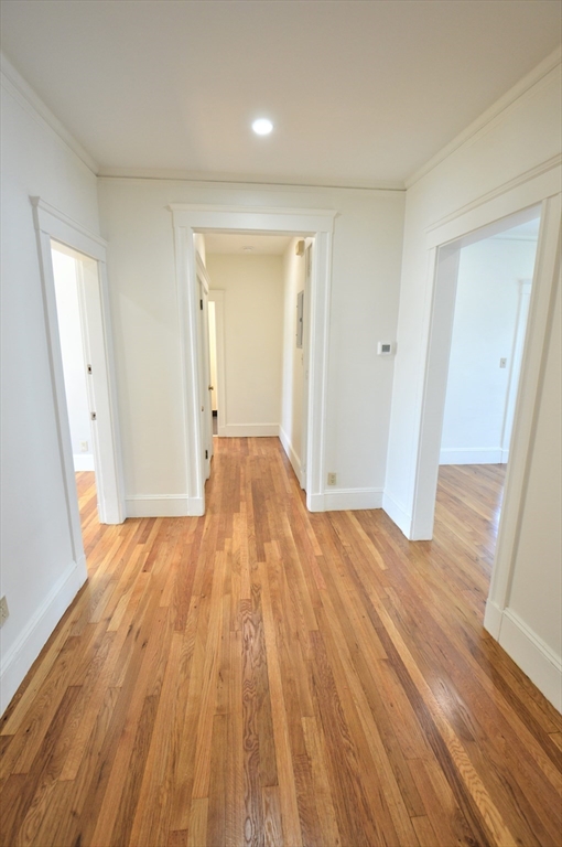 27 Ransom Road, Unit 2 Boston, MA 02135 - Photo 25 of 29 wooden floor in an empty room with a window