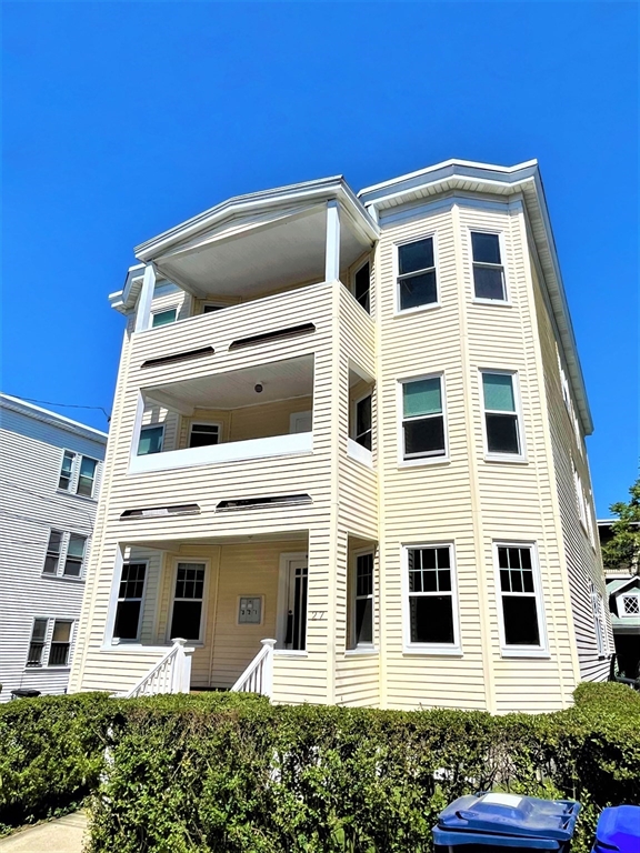 27 Ransom Road, Unit 2 Boston, MA 02135 - Photo 28 of 29 a front view of a building with a garden