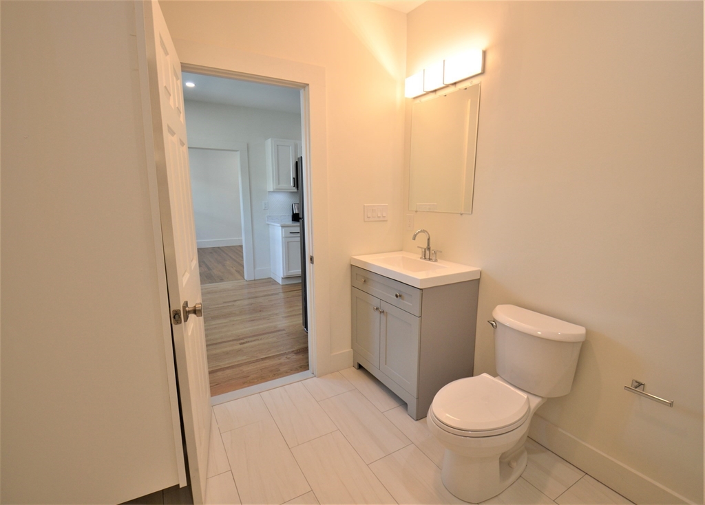 27 Ransom Road, Unit 2 Boston, MA 02135 - Photo 7 of 29 a bathroom with a sink toilet and shower