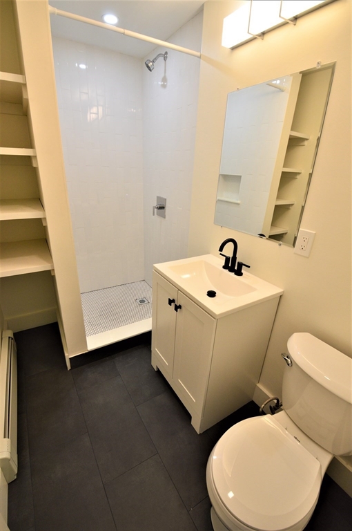 27 Ransom Road, Unit 2 Boston, MA 02135 - Photo 8 of 29 a white toilet sitting next to a bathroom sink