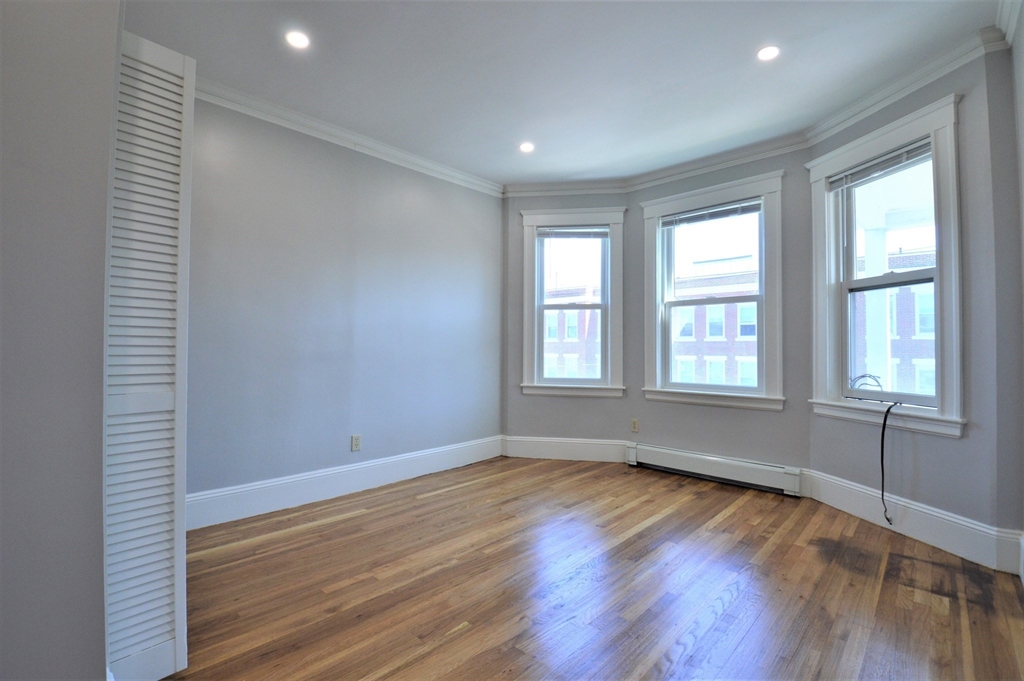 27 Ransom Road, Unit 2 Boston, MA 02135 - Photo 10 of 29 an empty room with wooden floor and windows