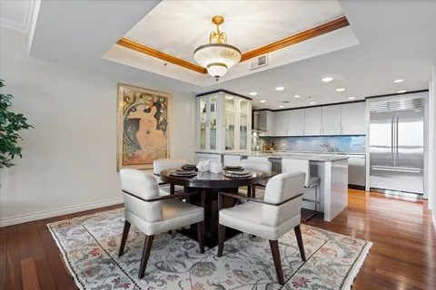 a view of a dining room with furniture wooden floor and a chandelier