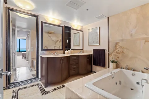 a bathroom with a tub sink and mirror