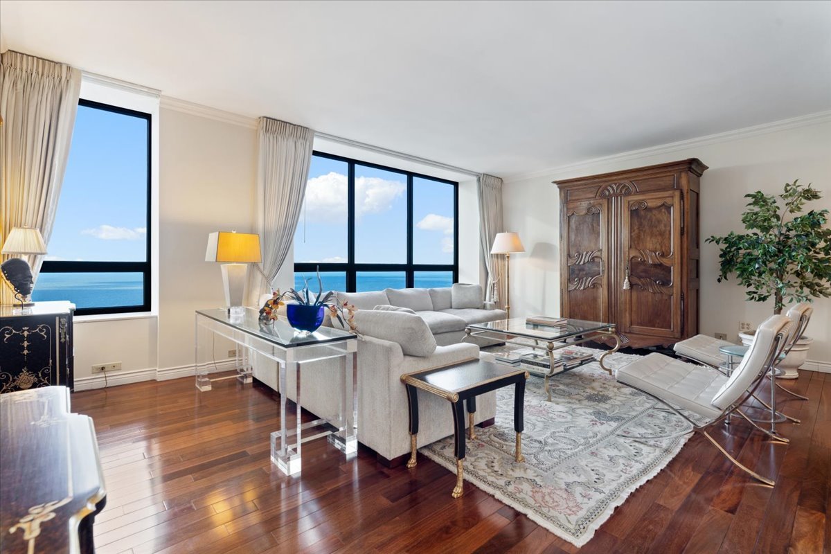 180 East Pearson Street, Unit 4002 Chicago, IL 60611 - Photo 7 of 33 a living room with furniture and wooden floor