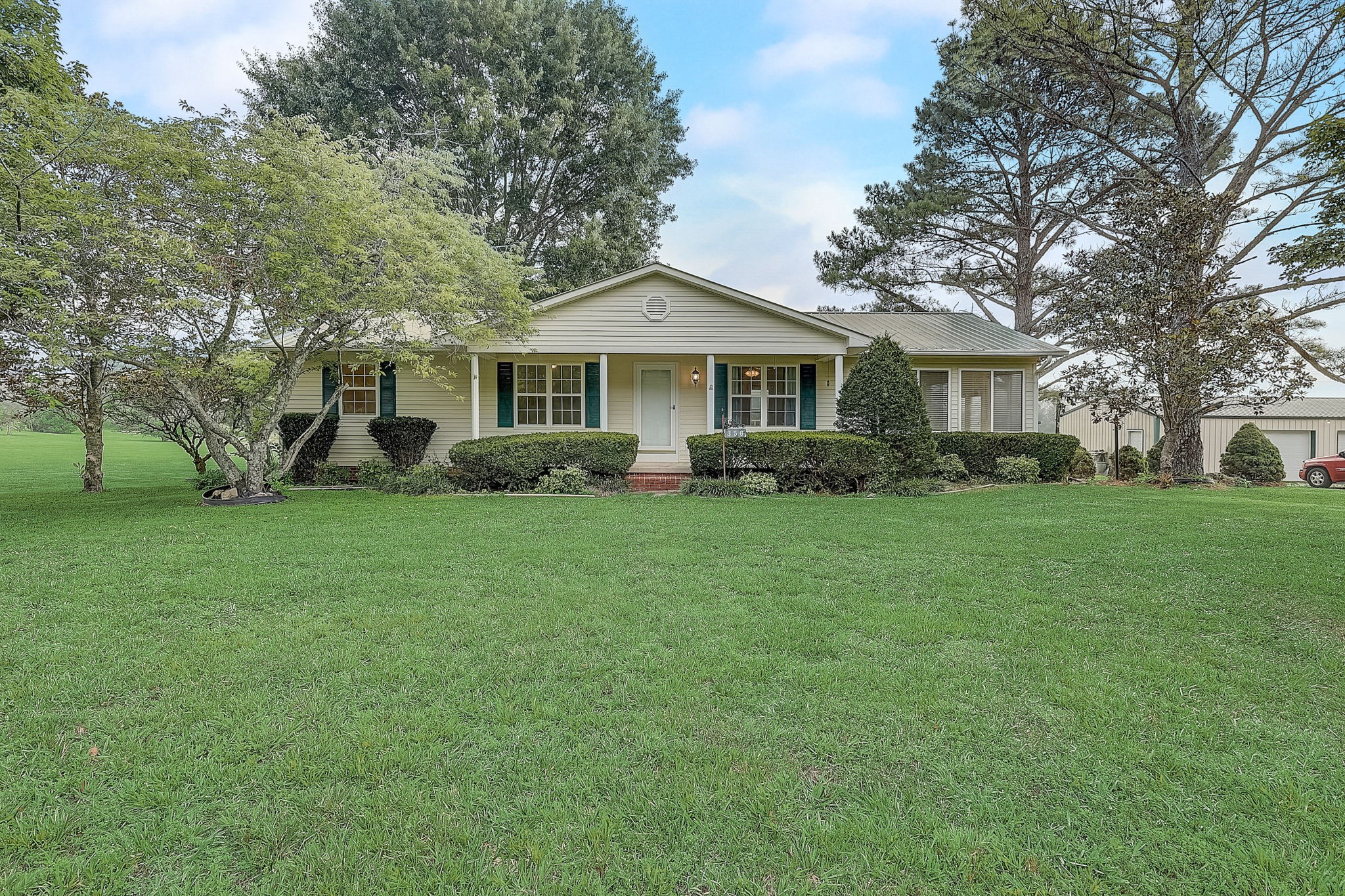a front view of house with yard and green space