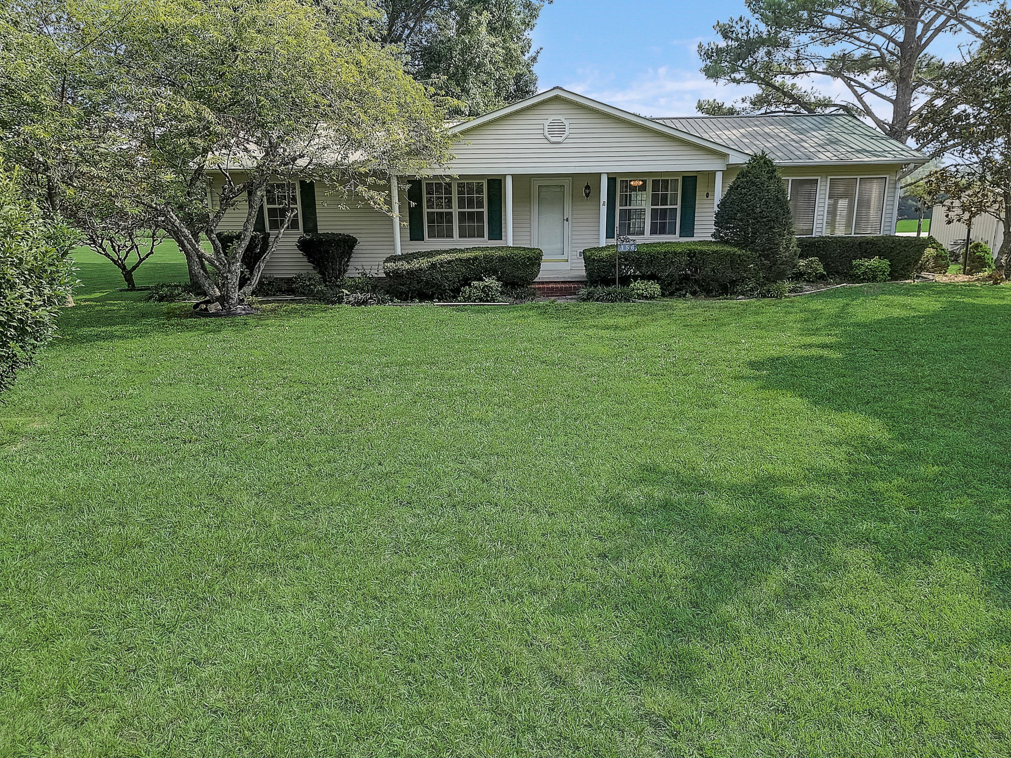 356 Howard Redmon Road Sparta, TN 38583 - Photo 59 of 68 a front view of a house with a garden and trees