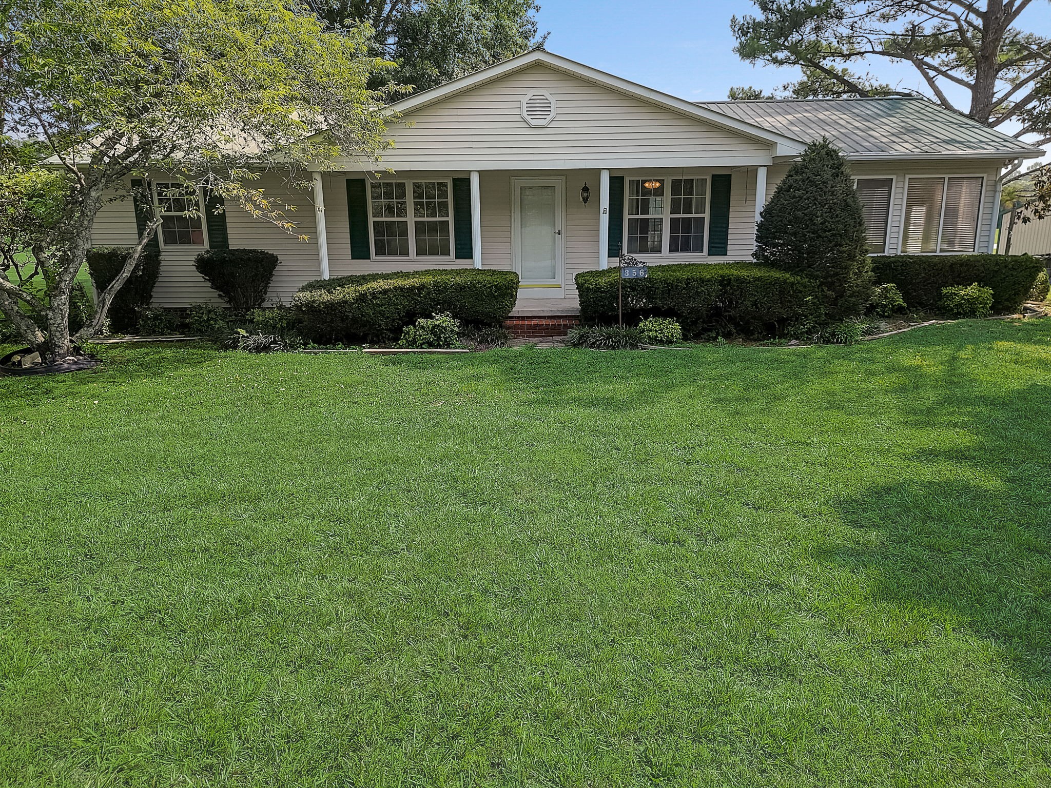 356 Howard Redmon Road Sparta, TN 38583 - Photo 60 of 68 a front view of a house with a garden and porch