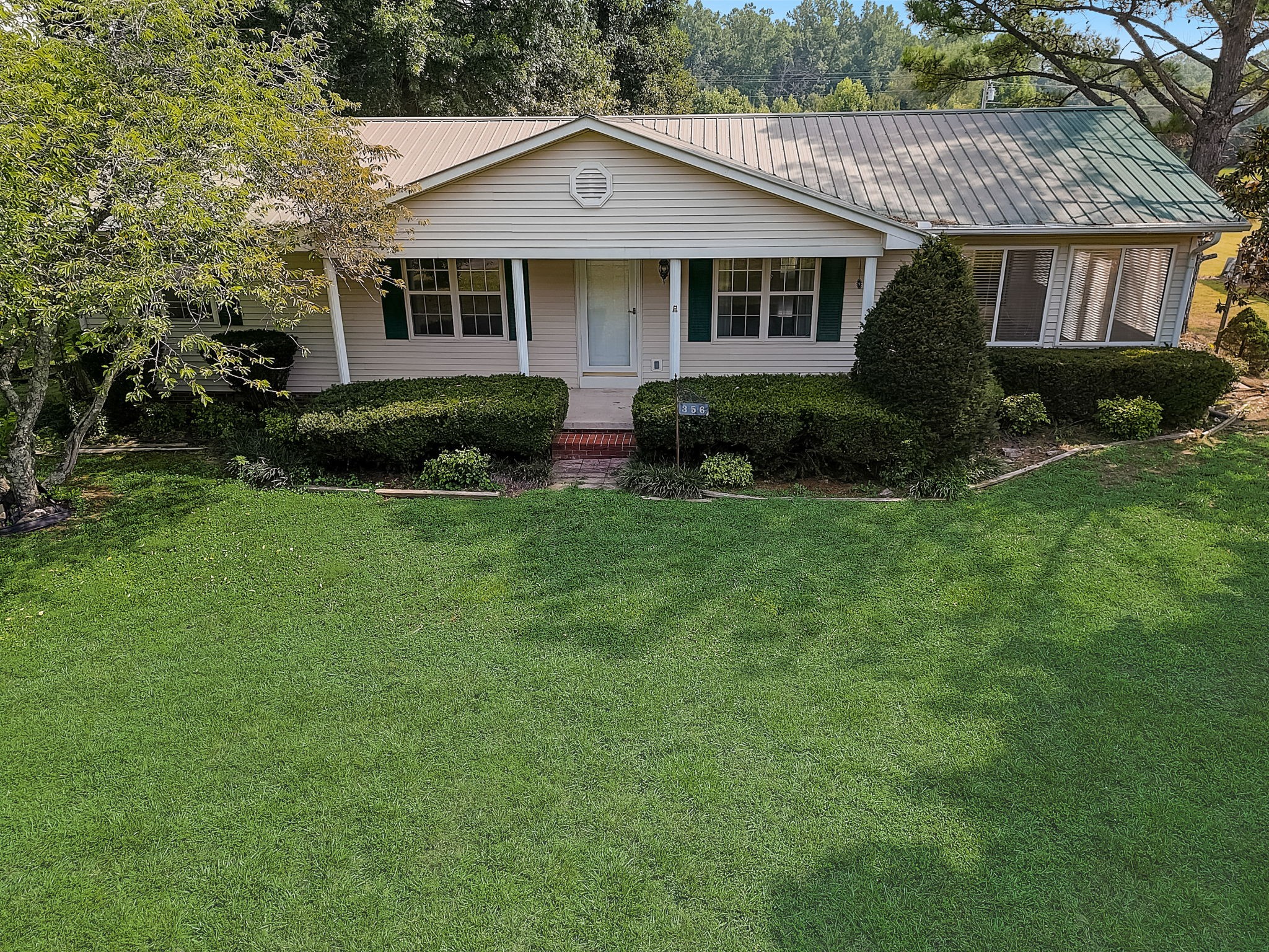 356 Howard Redmon Road Sparta, TN 38583 - Photo 62 of 68 a front view of a house with a yard and garage