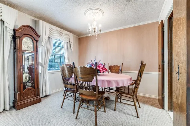 a view of a room with furniture and a flat screen tv
