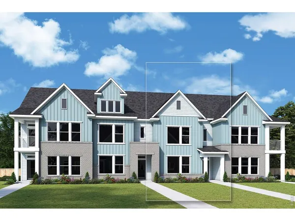 front view of a brick house next to a yard
