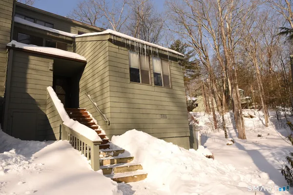 a view of a house with snow on the road