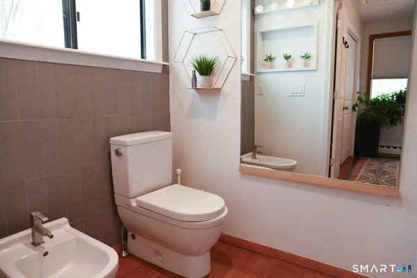 a bathroom with a glass shower door and a window
