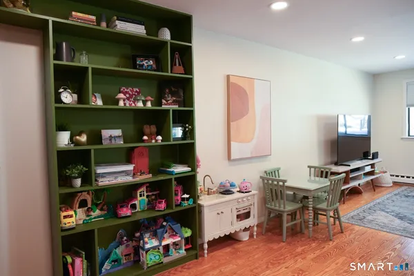 a room with a book shelf and a wooden floor