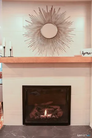 a fireplace with a vase on it and a sink