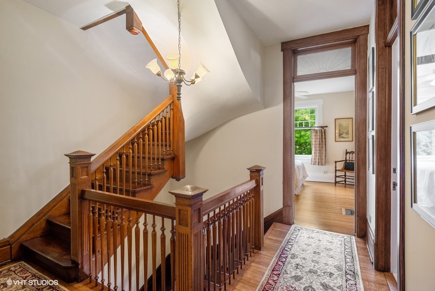 4050 North Kenmore Avenue Chicago, IL 60613 - Photo 15 of 32 a view of a hallway with wooden floor and stairs