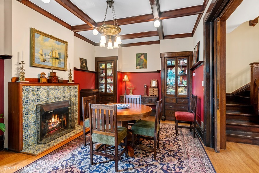 4050 North Kenmore Avenue Chicago, IL 60613 - Photo 10 of 32 a dining room with furniture a fireplace and wooden floor