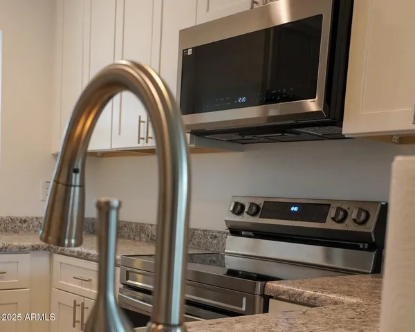 a kitchen with a refrigerator and a sink