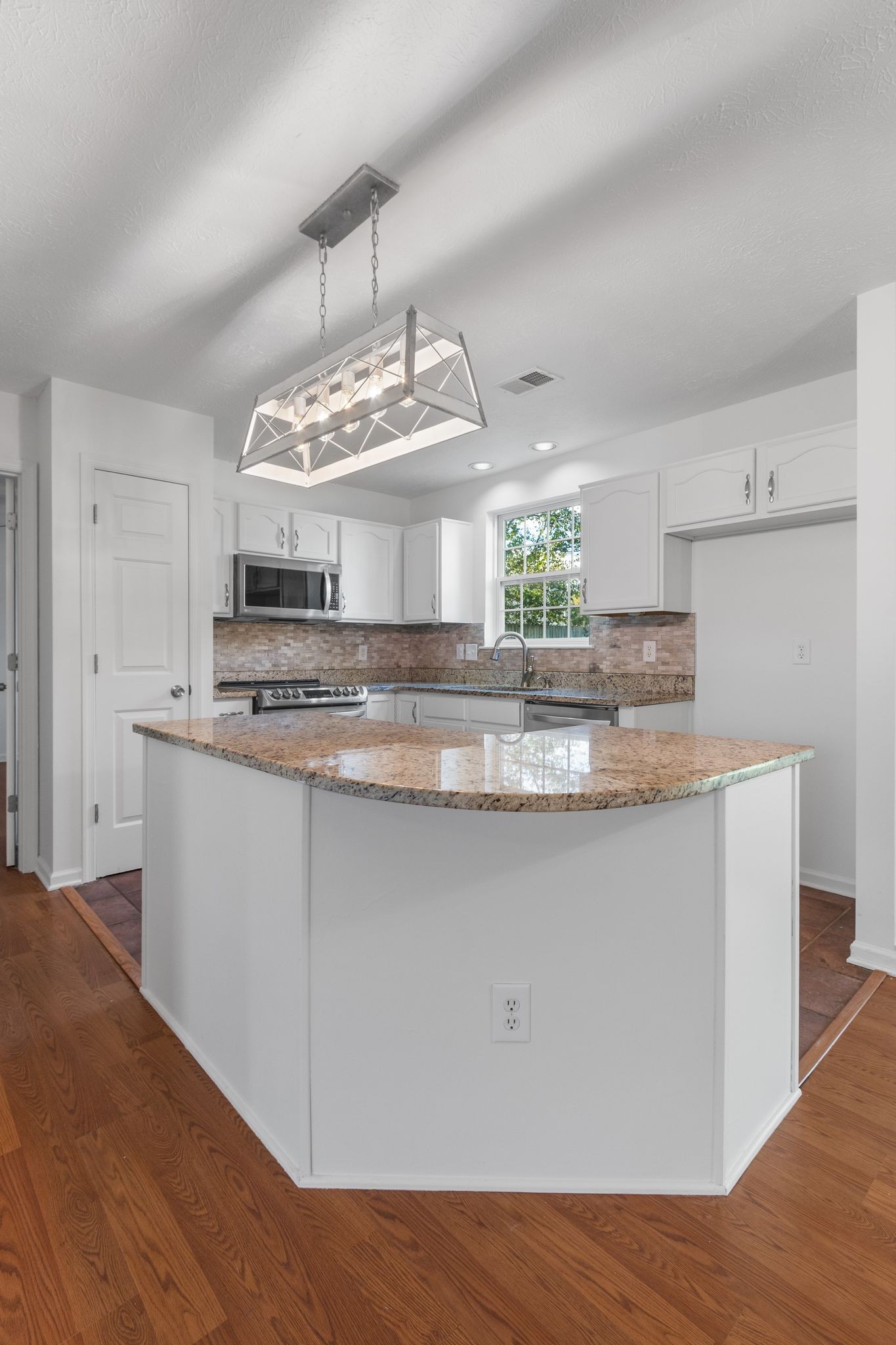 1413 Carmack Lane Spring Hill, TN 37174 - Photo 12 of 35 a view of kitchen with granite countertop stainless steel appliances stove and white cabinets