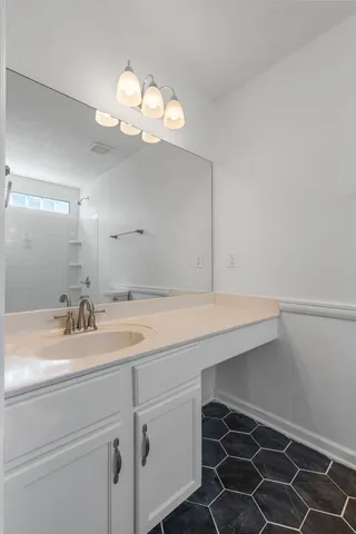 a bathroom with a sink and a mirror