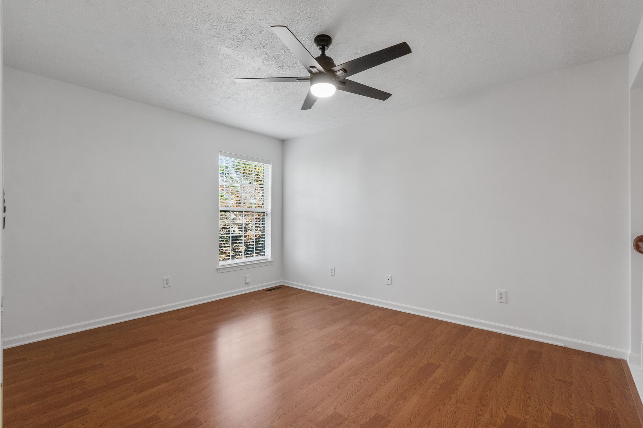 1413 Carmack Lane Spring Hill, TN 37174 - Photo 23 of 35 an empty room with wooden floor fan and windows