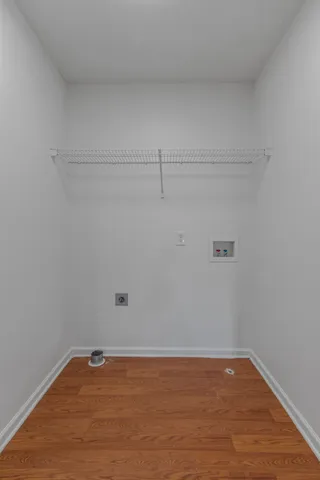 a view of a room with wooden floor