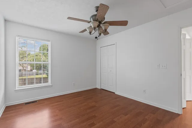 wooden floor in an empty room with a window