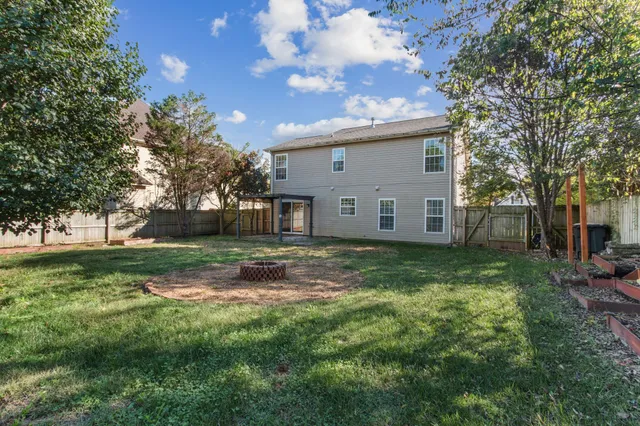 a view of a backyard with a large tree