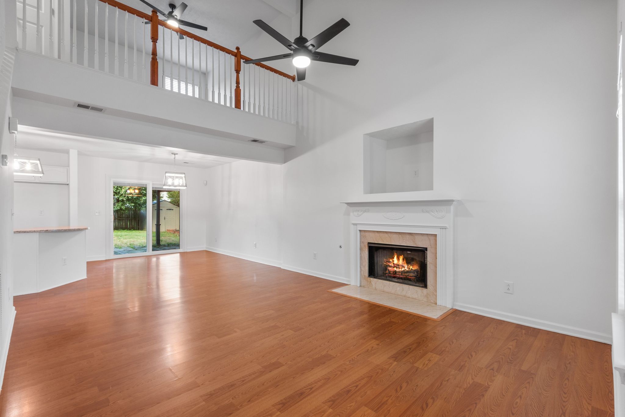 1413 Carmack Lane Spring Hill, TN 37174 - Photo 5 of 35 a view of an empty room with wooden floor fireplace and a window