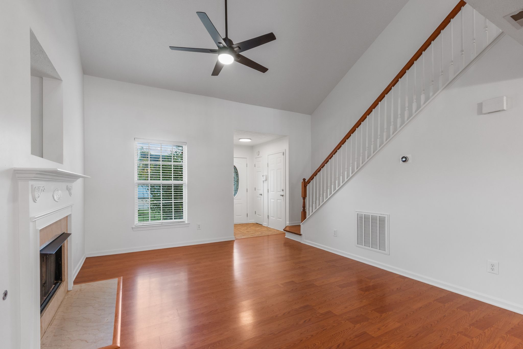 1413 Carmack Lane Spring Hill, TN 37174 - Photo 6 of 35 a view of an empty room with wooden floor and a window
