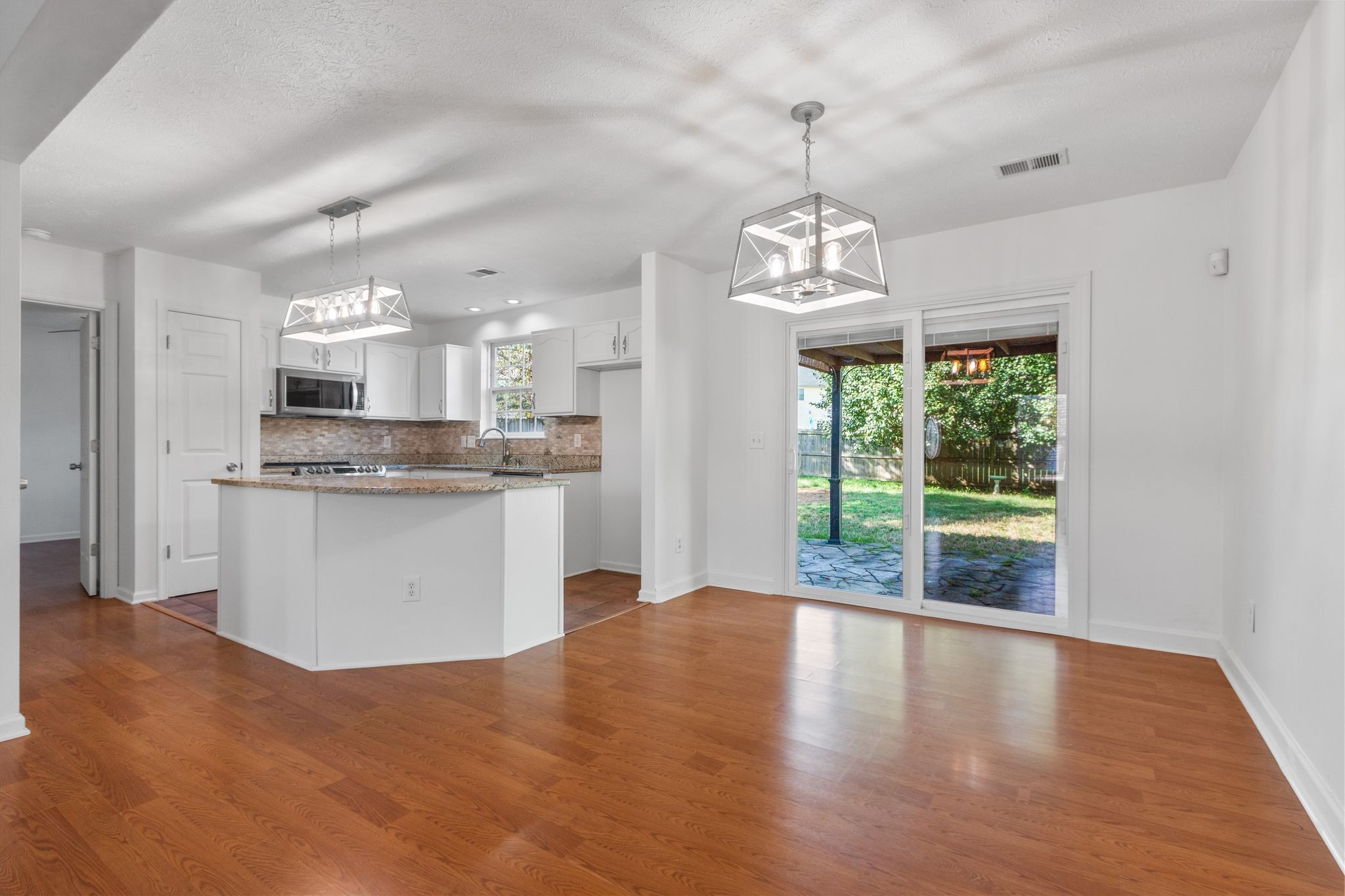 1413 Carmack Lane Spring Hill, TN 37174 - Photo 10 of 35 a view of a kitchen with granite countertop stainless steel appliances and a large window