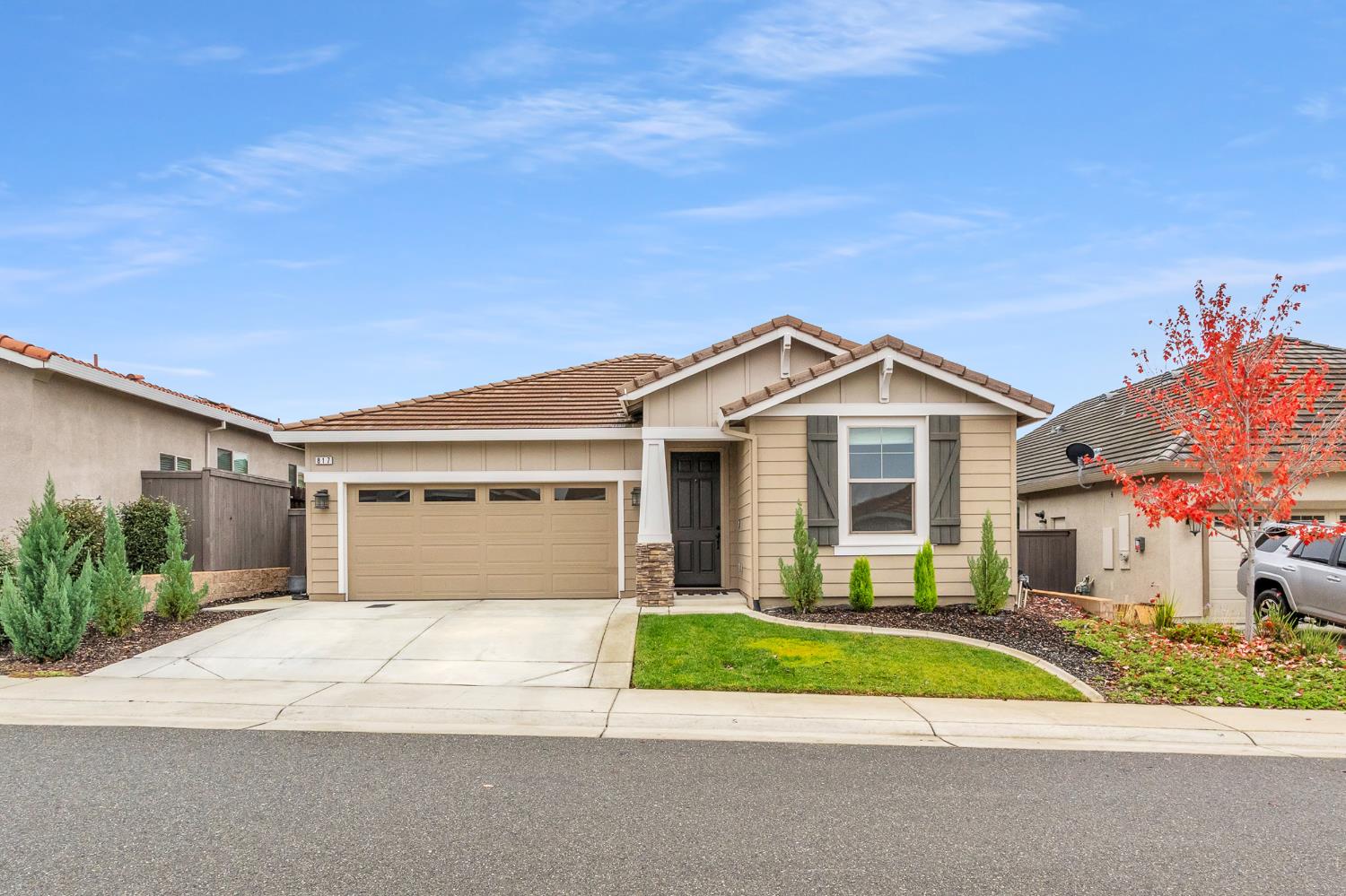 a front view of a house with a yard and garage