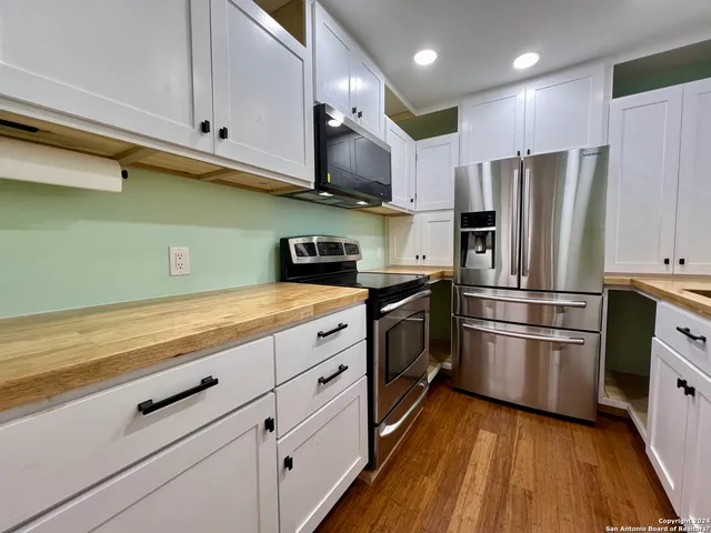 a kitchen with granite countertop stainless steel appliances and wooden cabinets